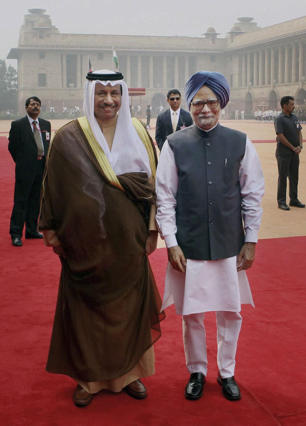 Kuwait’s Prime Minister Sheikh Jaber Al-Mubarak Al-Hamad Al-Sabah, left, and Indian Prime Minister Manmohan Singh pose for photographs during a ceremonial reception at the Presidential Palace in New Delhi.