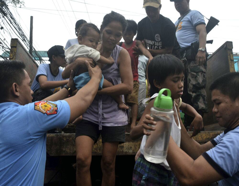Residents living near the slopes of Mayon volcano are evacuated to public schools by police in anticipation of the powerful typhoon Haiyan that threatened Albay province and several provinces in central Philippines.