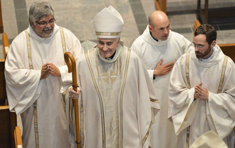 St. Cloud Diocese Bishop Donald J. Kettler smiles as he recesses from St. Mary`s Cathedral after his installation, in St. Cloud, Minn.