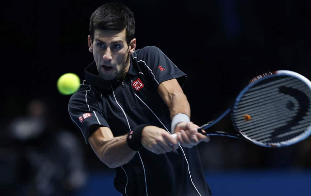 Novak Djokovic of Serbia plays a return to Juan Martin Del Potro of Argentina during their ATP World Tour Finals single tennis match at the O2 Arena in London.