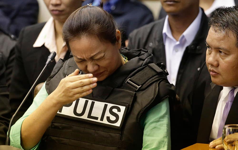 Janet Lim Napoles, a wealthy businesswoman who allegedly stole huge amounts of government development funds, derisively called pork-barrel funds, in conspiracy with powerful lawmakers, wipes her face as she testifies before the Senate Blue Ribbon Committee at suburban Pasay city, south of Manila, Philippines.