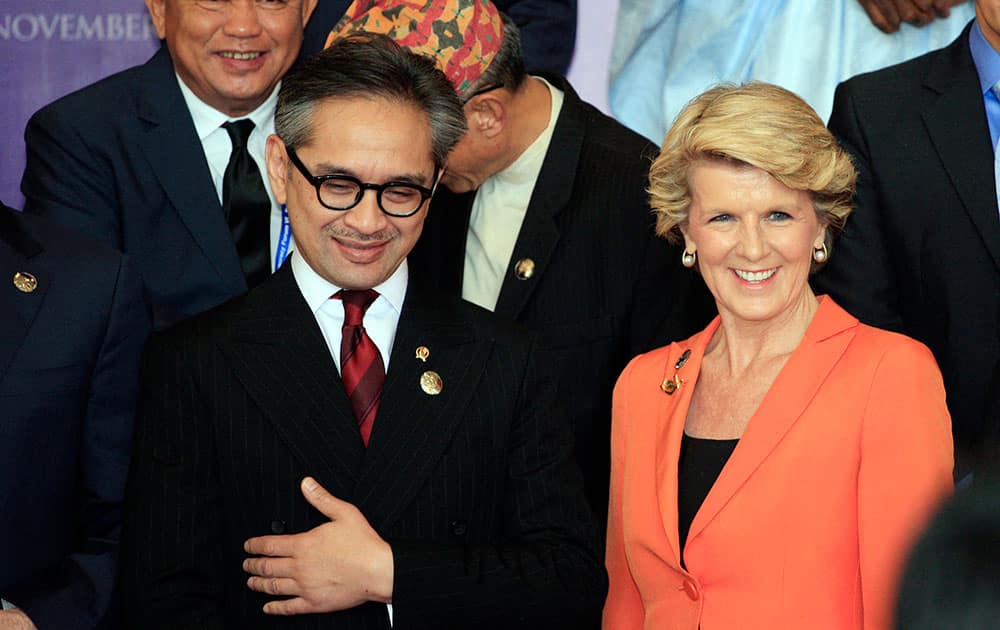 Indonesian Foreign Minister Marty Natalegawa, left,and Australian Foreign Minister Julie Bishop pose for photographs during the Bali Democracy Forum in Bali, Indonesia.