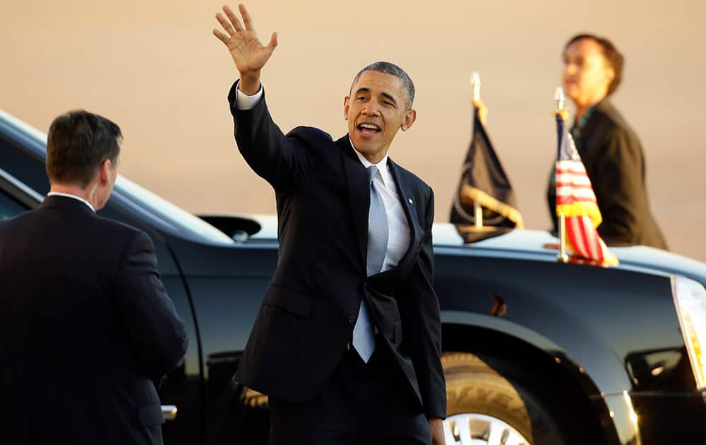President Barack Obama waves as he departs Love Field Airport after shaking hands with supporters following his arrival at Love Field Air Port, in Dallas.