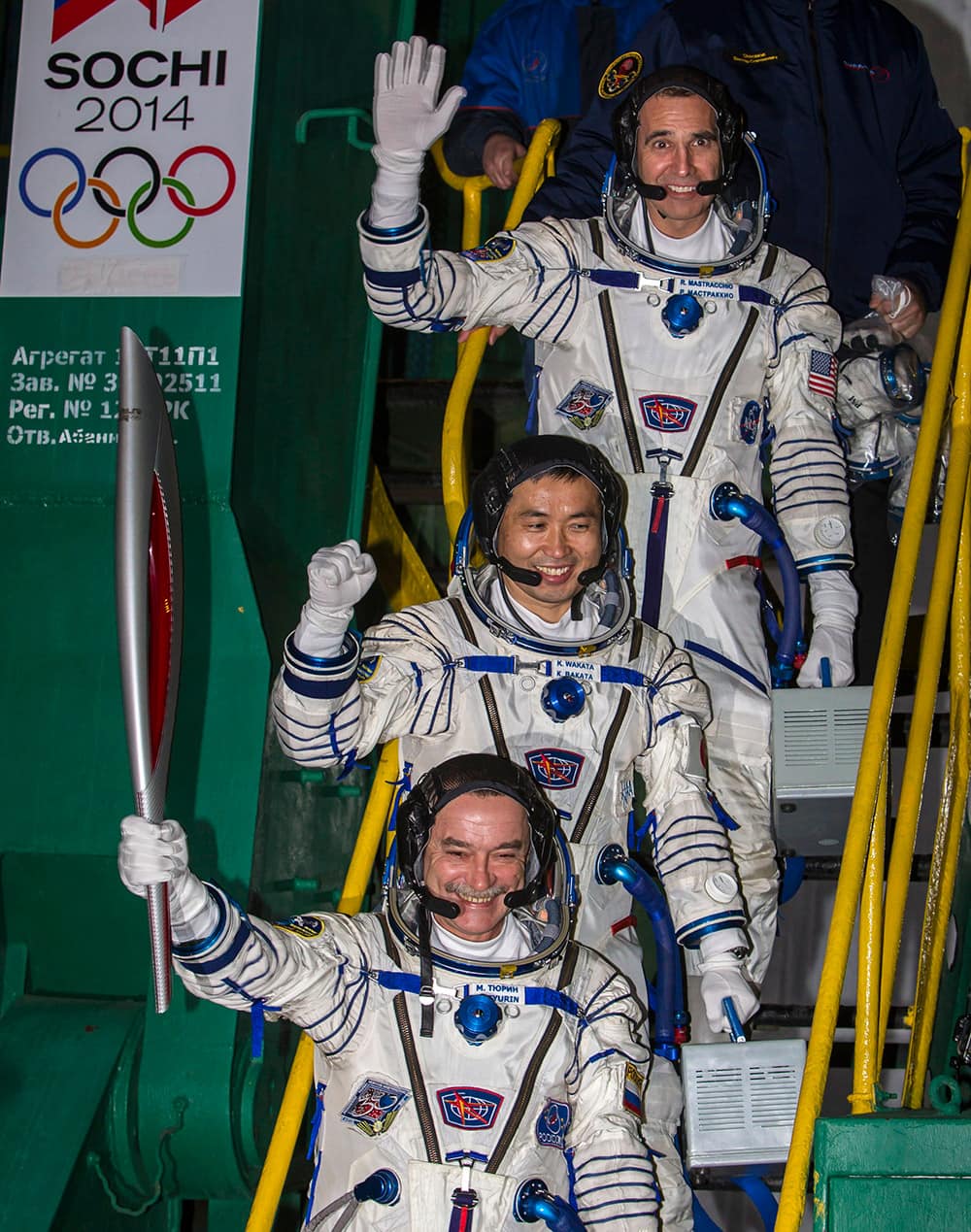 Japanese astronaut Koichi Wakata, center, Russian cosmonaut Mikhail Tyurin, bottom and U.S. astronaut Rick Mastracchio, crew members of the next mission to the International Space Station, pose with an Olympic torch prior the launch of Soyuz-FG rocket at the Russian leased Baikonur cosmodrome, Kazakhstan.