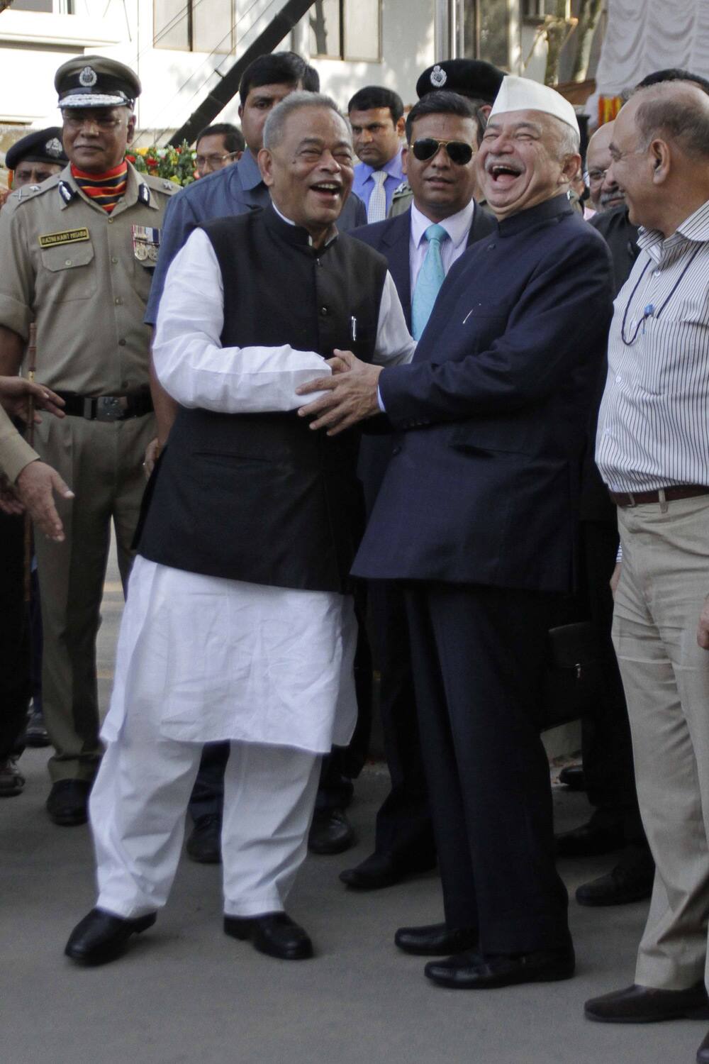 Indian Home Minister Sushilkumar Shinde shares a lighter moment with his Bangladeshi counterpart Muhiuddin Khan Alamgir after the inauguration of the India-Bangladesh joint retreat ceremony in Petrapole, about 100 kilometers (63 miles) east of Kolkata.