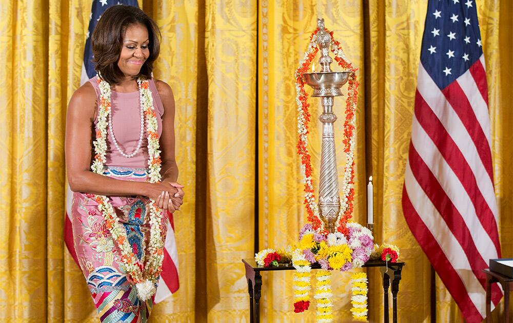 First lady Michelle Obama wears a garland of jasmine flowers during the White House Diwali celebration at the White House in Washington.