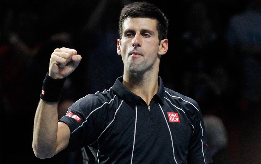 Novak Djokovic of Serbia celebrates his win against Roger Federer of Switzerland at the end their ATP World Tour Finals single tennis match at the O2 Arena in London.