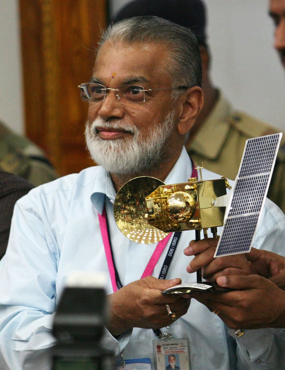 Indian Space and Research Organization Chairman, K.Radhakrishnan, poses for the media with a model of the Mars orbiter after its successful launch at Sriharikota, India.