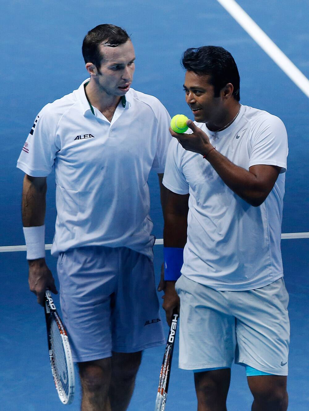 Leander Paes of India, right, talks to Radek Stepanek of Czech Republic during their ATP World Tour Finals double tennis match against Alexander Peya of Austria and Bruno Soares of Brazil at the O2 Arena in London.