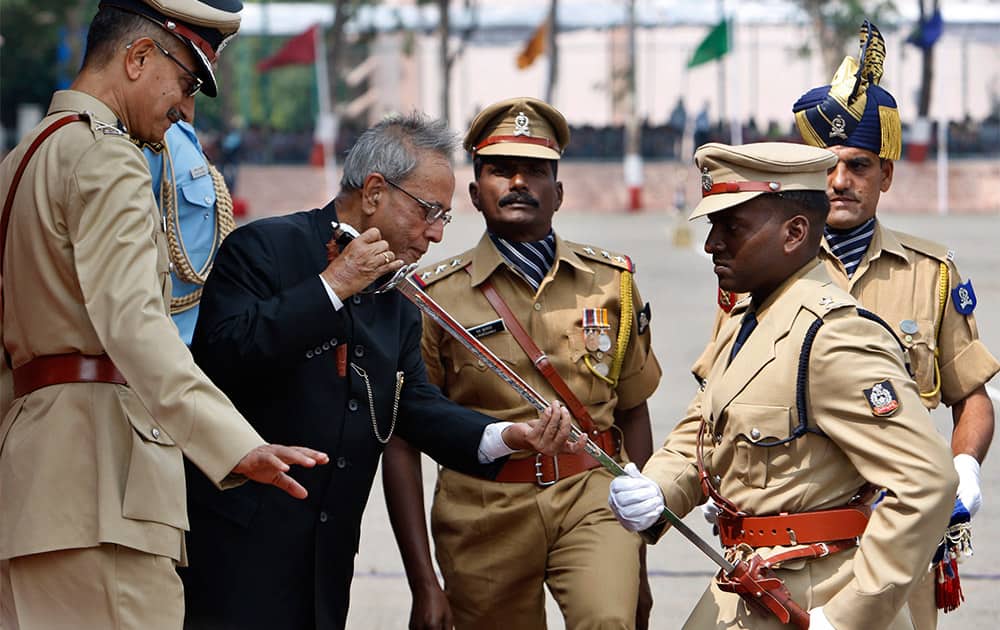 President Pranab Mukherjee, second left, presents a sword of honor for the Best Outdoor Officer Trainee to Bhaaskaran R, during the passing out parade of Indian Police Service (IPS) probationers of the 65th batch march at the Sardar Vallabhbhai Patel National Police Academy in Hyderabad.