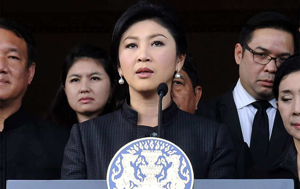 Thailand Prime Minister Yingluck Shinawatra, center, flanked by Cabinet ministers and aides, speaks during a news conference at the government house in Bangkok, Thailand.