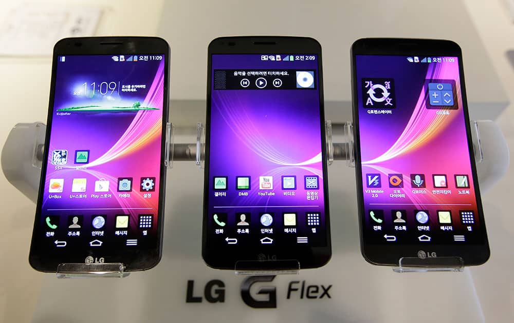 Three LG Electronics` G Flex smartphones are displayed during a media event at its head office in Seoul, South Korea.