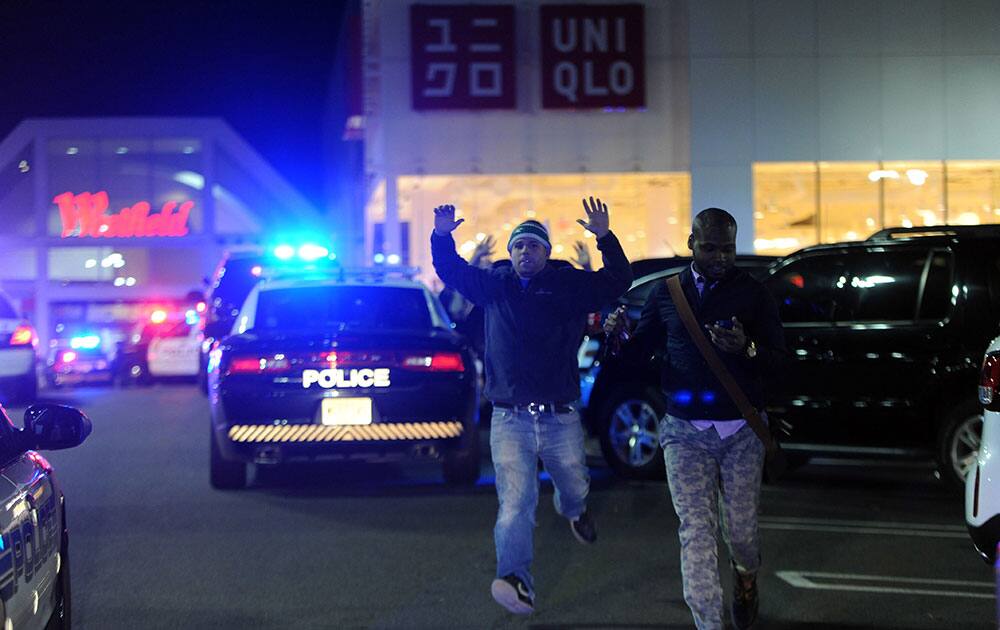 Patrons flood out of the Garden State Plaza Mall after multiple shots were fired inside the mall shortly before closing time Monday Nov. 4, 2013.