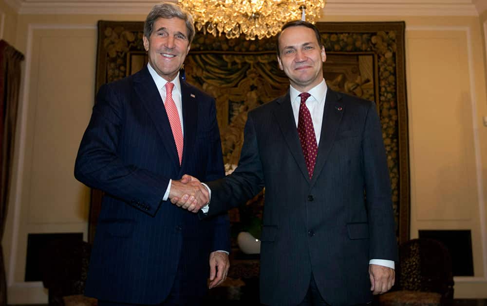 U.S. Secretary of State John Kerry, left, poses with Polish Foreign Minister Radoslaw Sikorski in Warsaw.