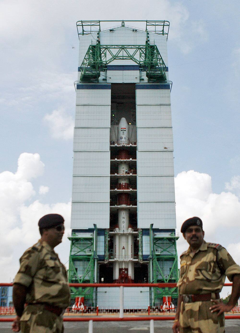 Paramilitary soldiers stand guard near the Polar Satellite Launch Vehicle (PSLV-C25) at the Satish Dhawan Space Center at Sriharikota, in the southern Indian state of Andhra Pradesh.