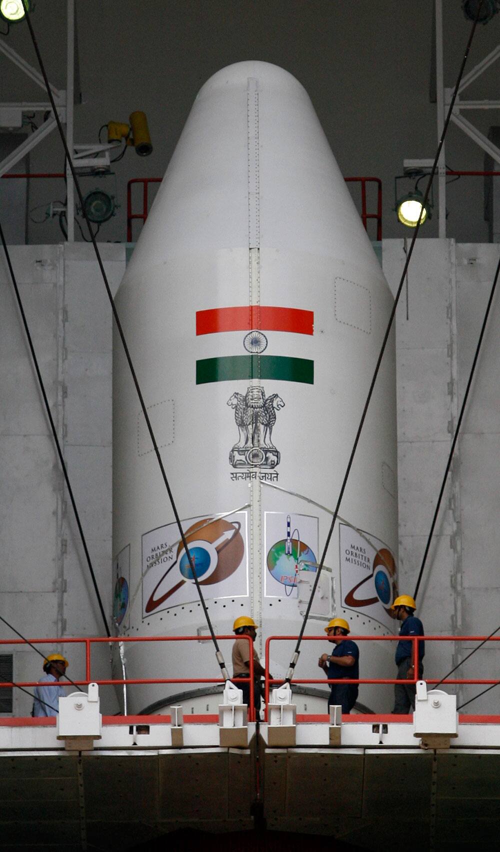 Technicians inspect the Polar Satellite Launch Vehicle (PSLV-C25) at the Satish Dhawan Space Center at Sriharikota, in the southern Indian state of Andhra Pradesh.