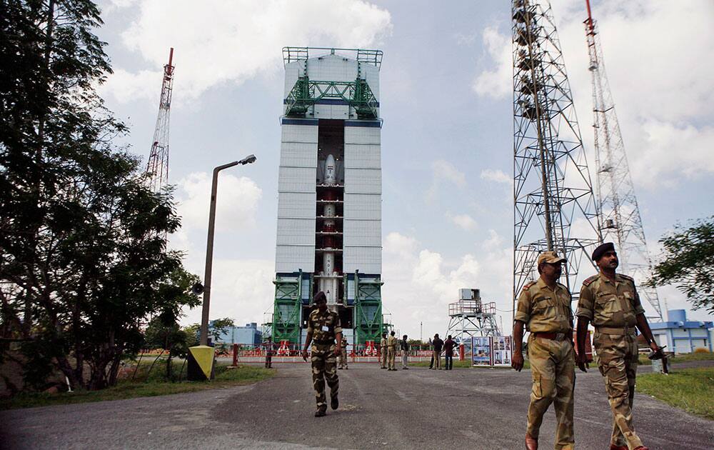 Central Industrial Security Force (CISF) personnel walk near the Polar Satellite Launch Vehicle (PSLV – C25) at the Satish Dhawan Space Center at Sriharikota, in the southern Indian state of Andhra Pradesh.