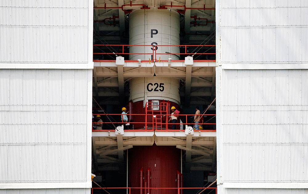 Technicians inspect the Polar Satellite Launch Vehicle (PSLV-C25) at the Satish Dhawan Space Center at Sriharikota, in the southern Indian state of Andhra Pradesh.