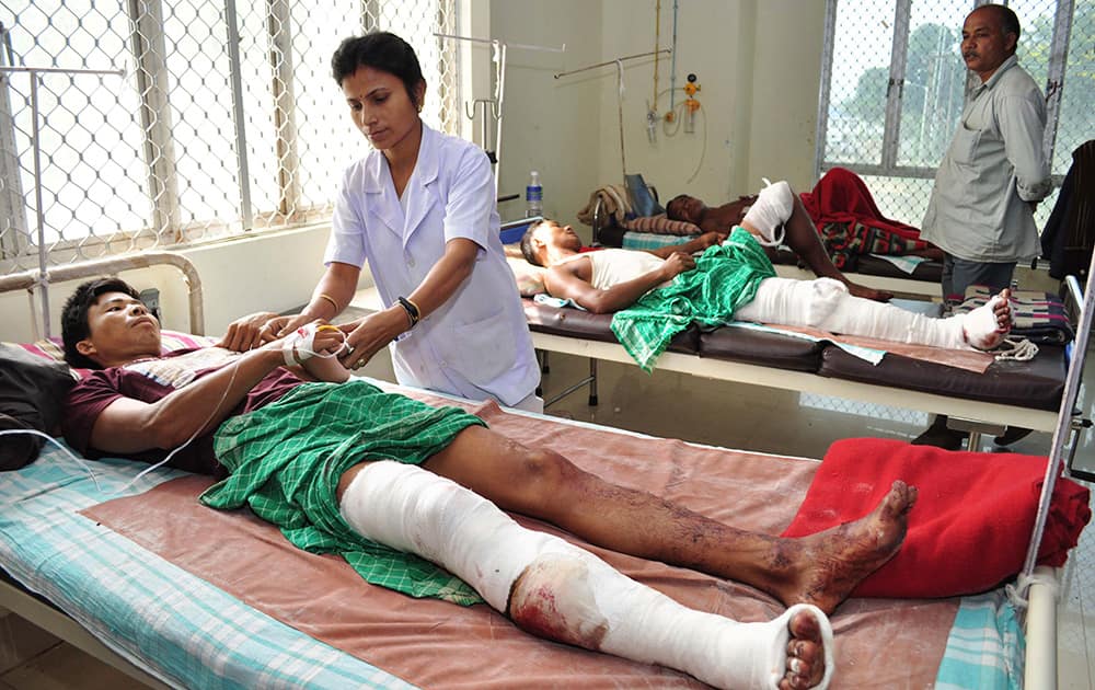 People injured in a Sunday night attack by a rival tribal group in Assam`s Goalpara district receive treatment at a hospital in Gauhati.