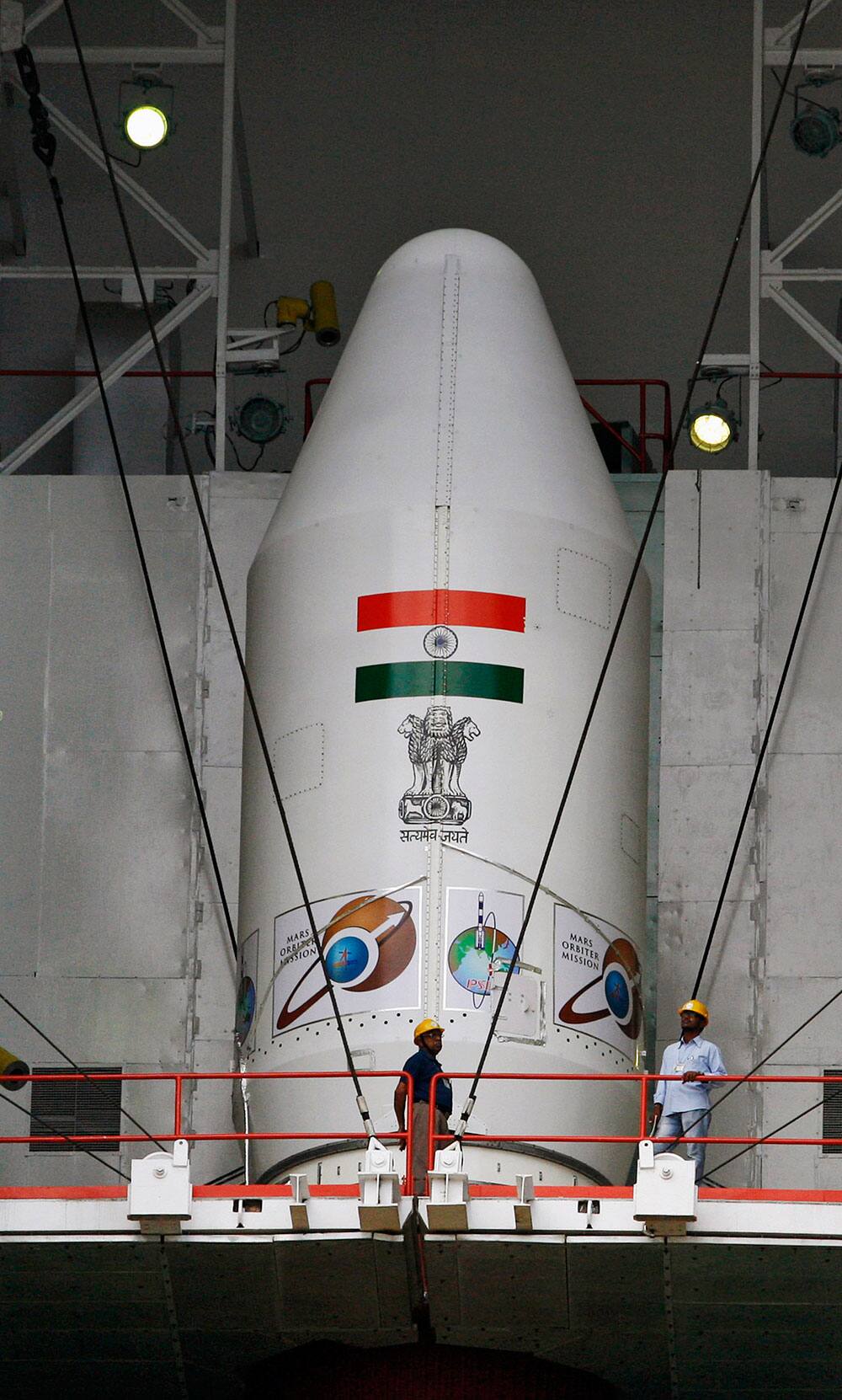 Indian technicians inspect the Polar Satellite Launch Vehicle (PSLV – C25) at the Satish Dhawan Space Center at Sriharikota, in the southern Indian state of Andhra Pradesh.
