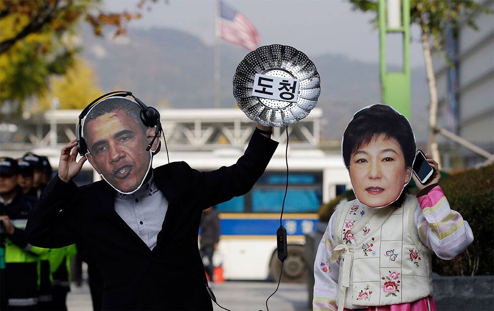 South Korean protesters wearing masks of US President Barack Obama, left, and South Korean President Park Geun-hye perform during a rally denouncing US National Security Agency`s alleged spying on its allies near the US Embassy in Seoul, South Korea.