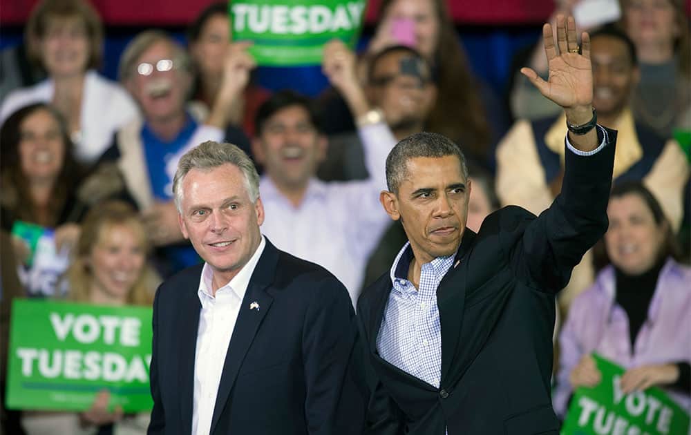 President Barack Obama appears at a campaign rally with supporters for Virginia Democratic gubernatorial candidate Terry McAuliffe, left, at Washington Lee High School in Arlington, Va.