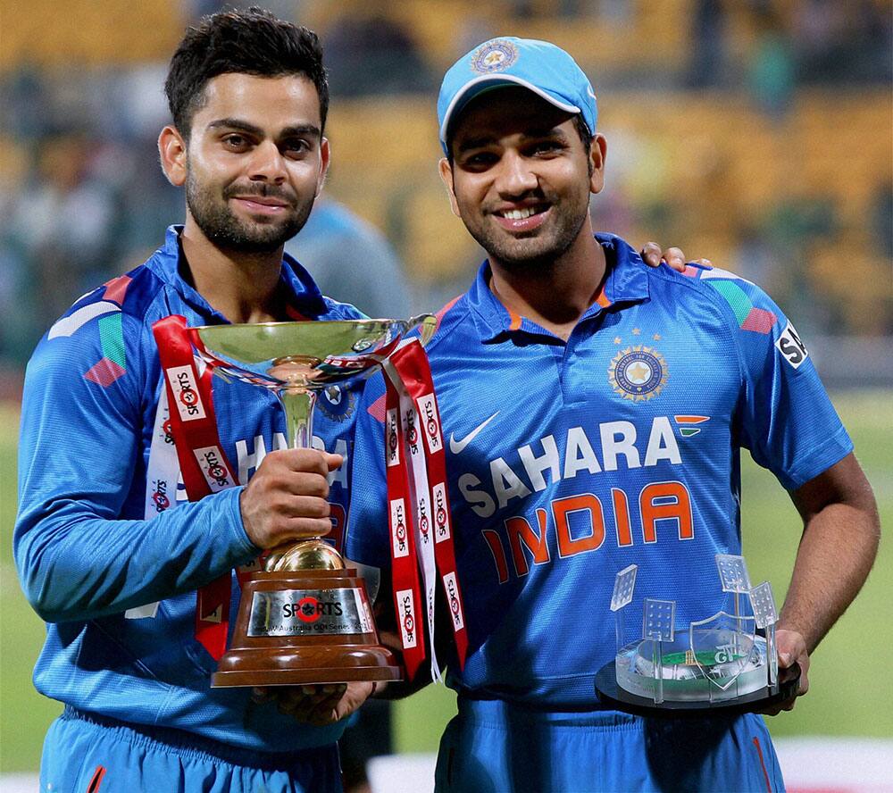Indian players Rohit Sharma and Virat Kohli with the trophy after India beat Australia in the 7th ODI by 57 runs to win series 3-2 in Bangalore.