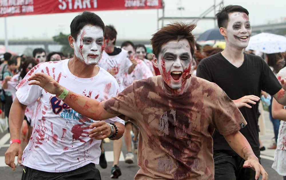 Runners dressed as zombies race during the Taipei Zombie Run at the Dajia Riverside Park in Taipei, Taiwan.
