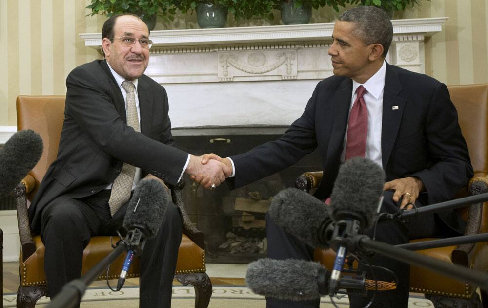 President Barack Obama and Iraqi Prime Minister Nouri al-Maliki shakes hands, their meeting in the Oval Office of the White House in Washington.
