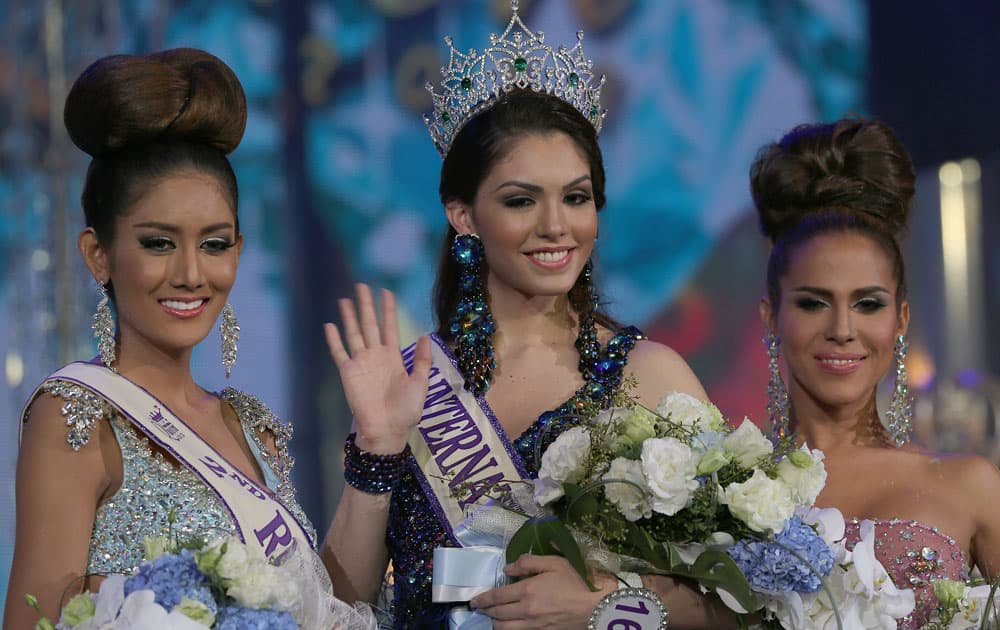 Marceki Ohio of Brazil, poses with the two runners-up Nethnapada Kanrayanon of Thailand and Shantell D`Marco of the US, after winning the crown at the Miss International Queen 2013 transvestite beauty pageant, in Pattaya.