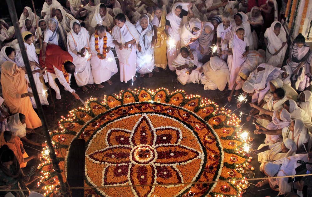 Widows celebrating Diwali by lighting crackers for the first time during a function organized by an NGO, Sulabh International, in Vrindaban.