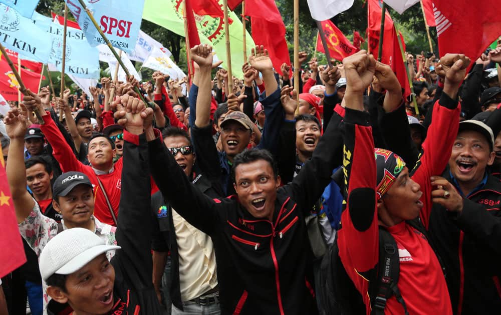 Indonesian workers shout slogans during a demonstration demanding higher wages outside the city hall in Jakarta.