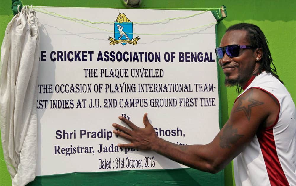 West Indies Cricketer Chris Gayle unveils a plaque during a practice match against UPCA at Jadavpur University Ground in Kolkata.