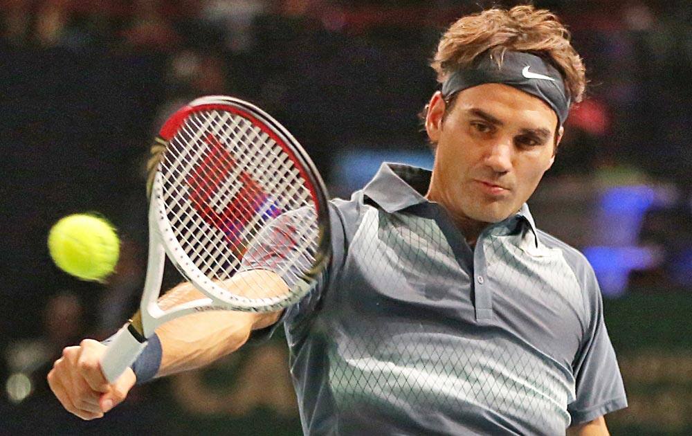 Switzerland`s Roger Federer returns the ball to South Africa`s Kevin Anderson, during their second round match at the Paris Masters tennis, in the Paris Bercy stadium.