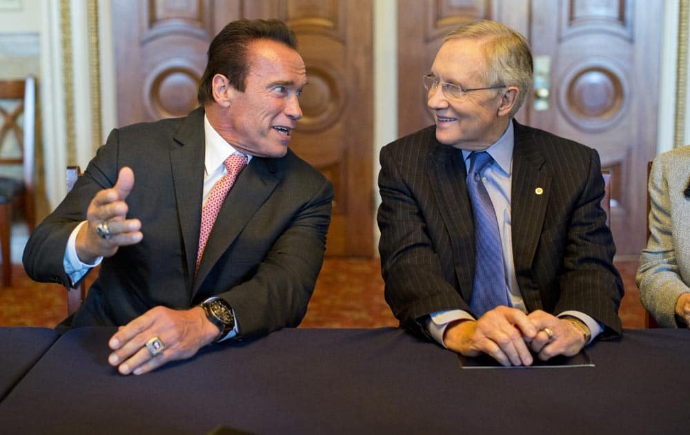 Former California Gov. Arnold Schwarzenegger, talks with Senate Majority Leader Harry Reid of Nev., before a meeting about funding after school programs, on Capitol Hill in Washington.