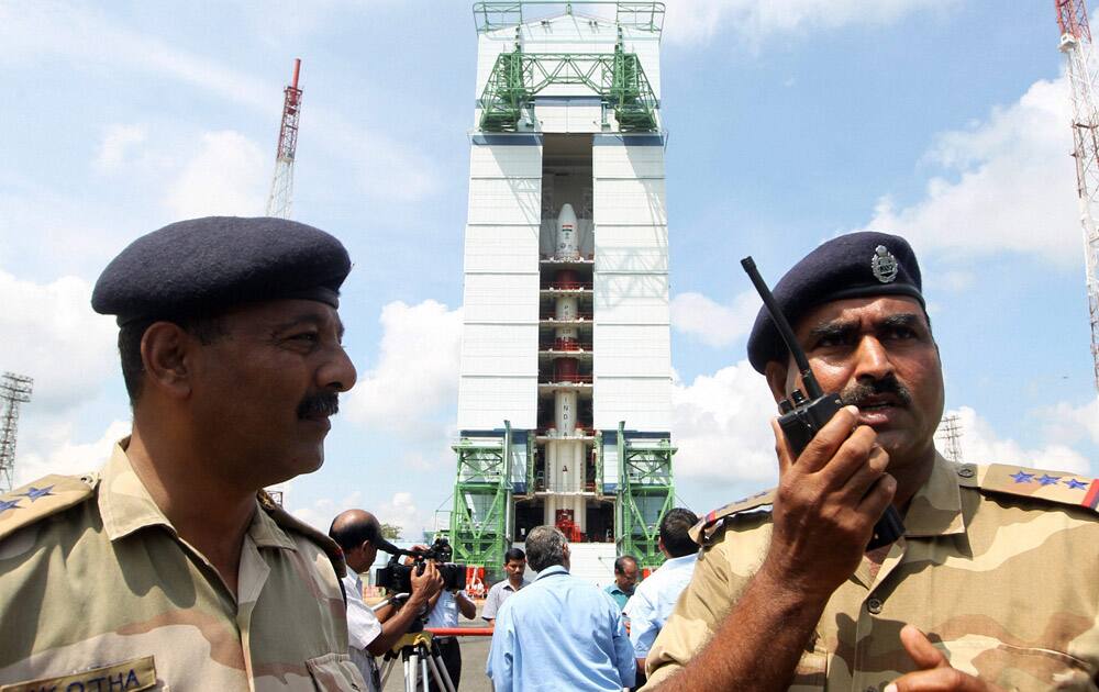 Security person stand in front of Mars Orbiter Mission in the First Launch Pad at Satish Dhawan Space Centre in Sriharikota on Wednesday. Mars Orbiter Mission on board PSLV C25 is scheduled to be launched on November 5.