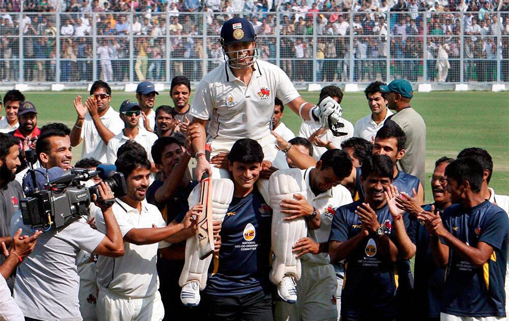 Mumbai players carry Sachin Tendulkar on shoulders as they celebrate after beating Haryana in their Ranji Trophy match in Rohtak.