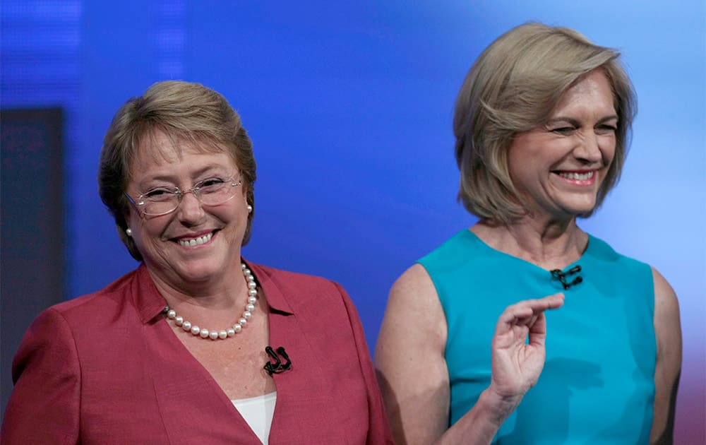 Presidential candidates Michelle Bachelet, left, and Evelyn Matthei, right, smile before the start of a debate at a television station in Santiago, Chile.
