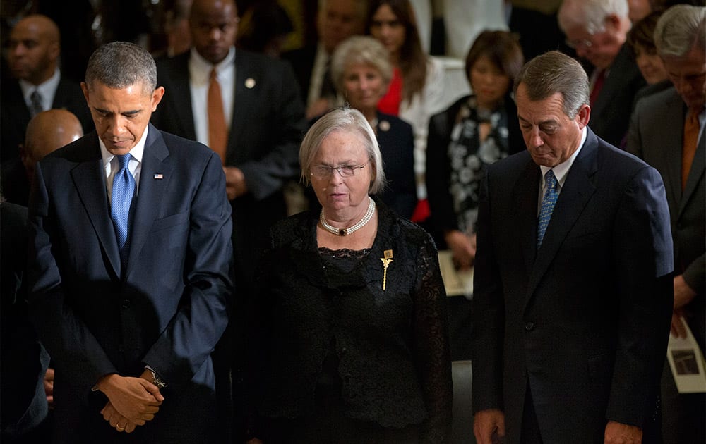 President Barack Obama, Heather Foley, and House Speaker John Boehner of Ohio, bow their heads at a memorial service for the former Speaker of the House Thomas S. Foley at Statuary Hall at the US Capitol in Washington.