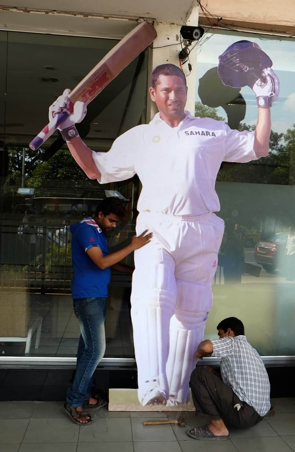 Workers erect a cut-out of Sachin Tendulkar at the entrance to Eden Gardens, the venue of the first test match between India and West Indies, in Kolkata.