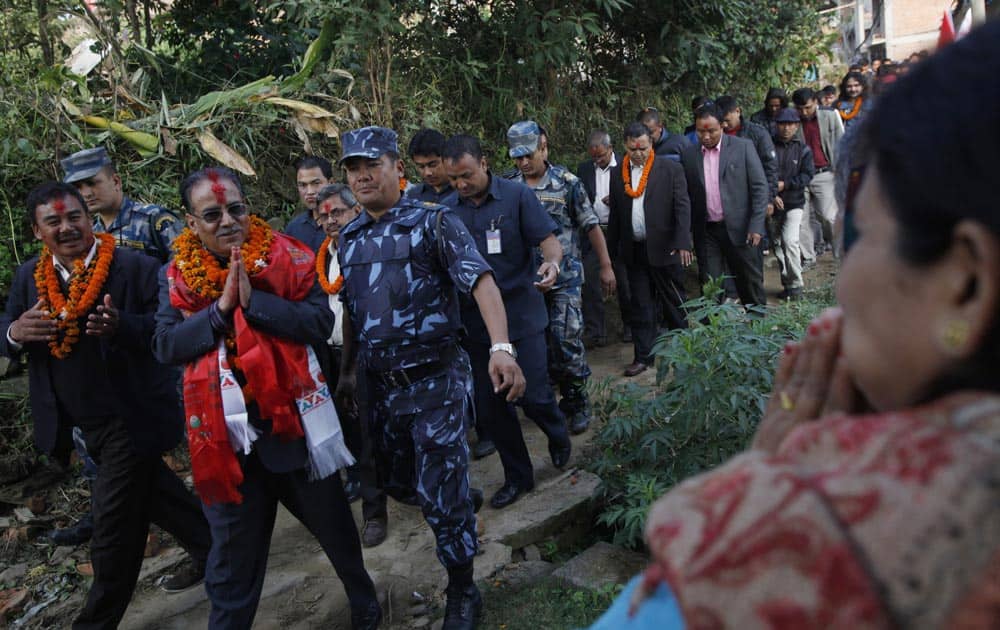 Nepal’s Communist Party Maoist Chairman Pushpa Kamal Dahal, second left, greets supporters during an election campaign ahead of the Constituent Assembly elections in Katmandu, Nepal.
