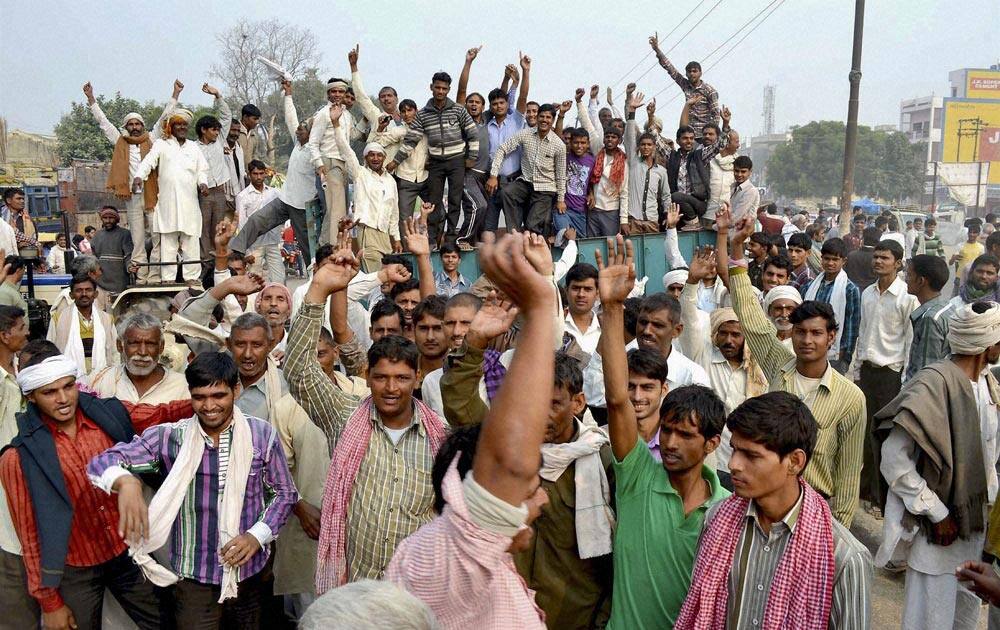 Hundreds of farmers blocking Agra-Delhi National Highway-2 protesting against the low prices offered by traders for their paddy crop in Mathura.