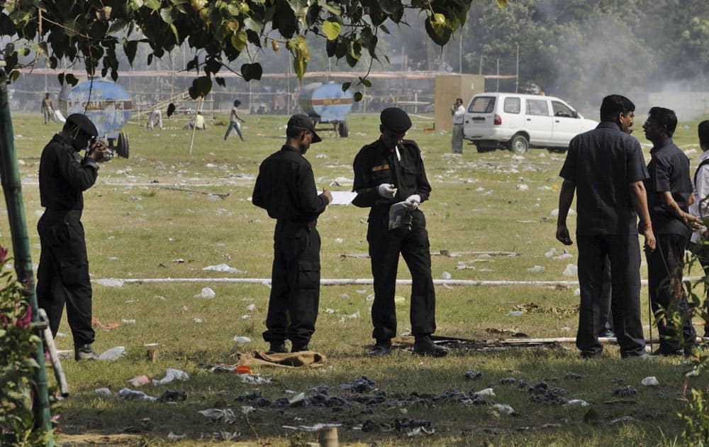 National Security Guard soldiers collect evidence from the site of bomb blasts at a central park in Bihar’s state capital of Patna.