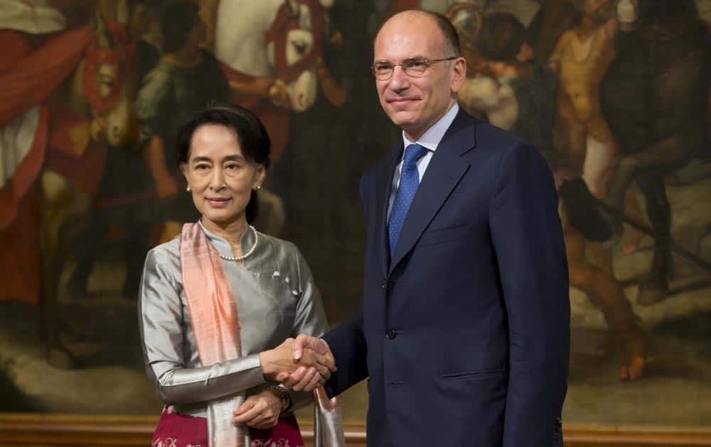 Aung San Suu Kyi, Myanmar`s Nobel Peace Prize laureate and former long-time political prisoner, left, and Italian Premier Enrico Letta shake hands for the media ahead of their meeting, at Palazzo Chigi, in Rome.