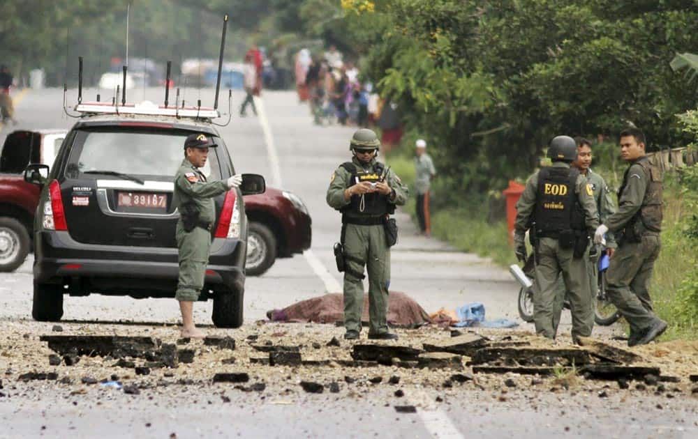 Thai Explosive Ordnance Disposal officers inspect the site where their colleagues were killed by a bomb detonated by suspected muslim insurgents in Bacho district in Narathawat province, southern Thailand.