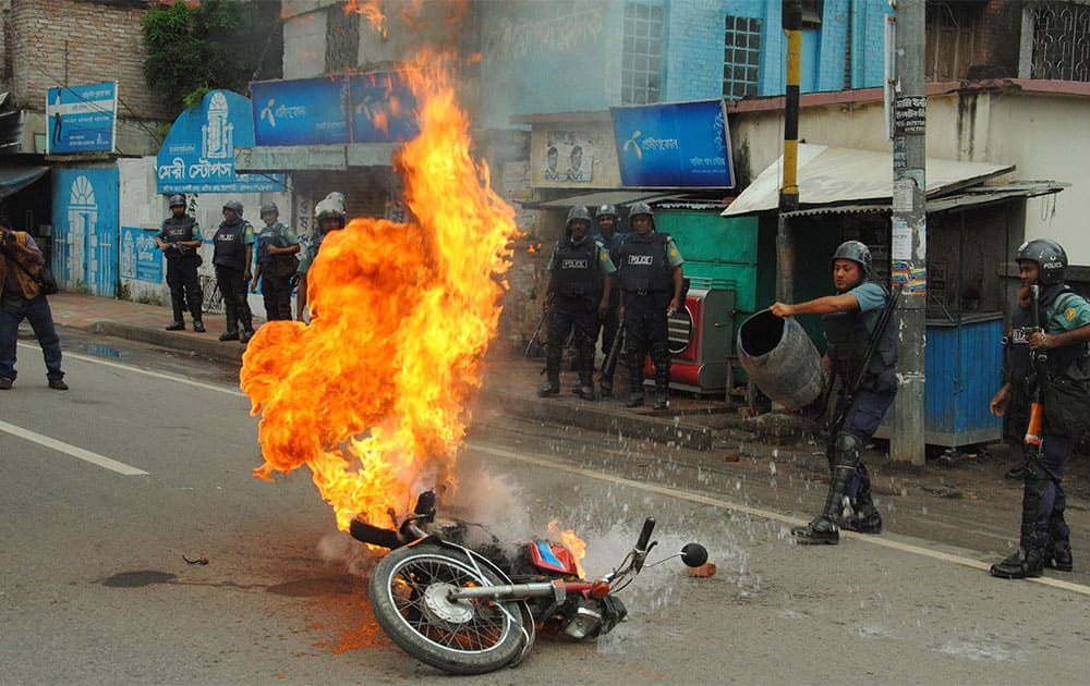 Bangladeshi police officers try to douse the flames on a motorcycle allegedly ignited by opposition activists during a general strike in Rajshahi, outskirts of Dhaka.