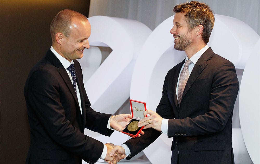 Denmark`s Crown Prince Frederik, right, presents the Prince Henrik`s Medal of Honor to the General Manager of ECCO Shoes, Morten Lauge, at an official ceremony of the Diploma of the Danish Export Association and His Royal Highness Prince Henrik`s Medal of Honor in Sydney, Australia.