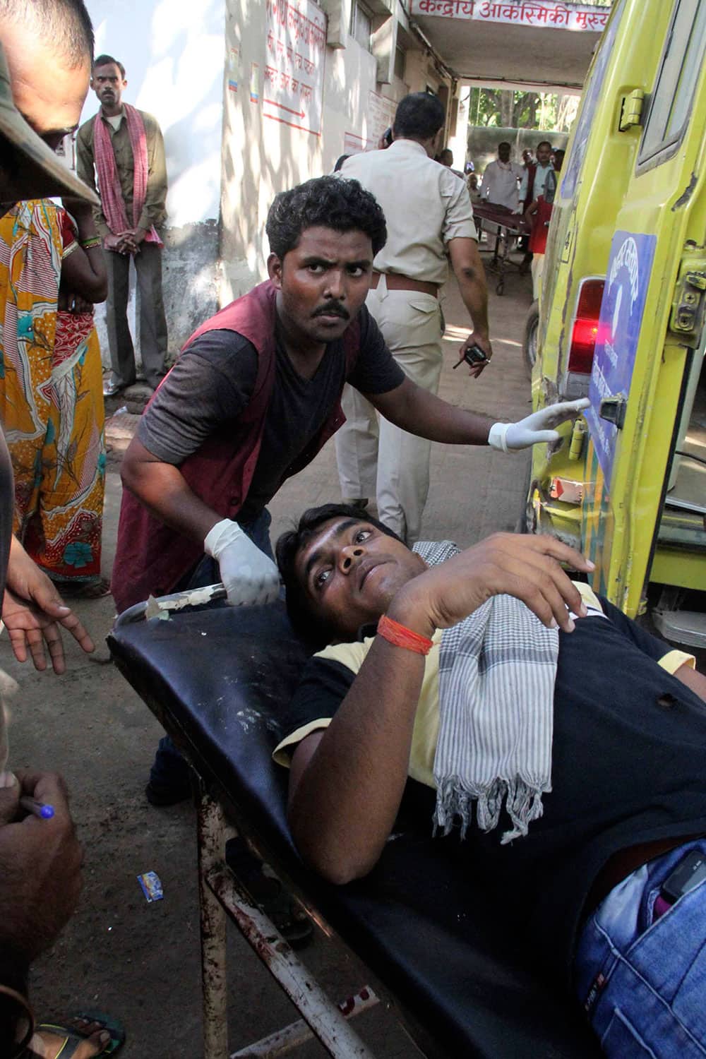 A man injured in bomb blasts is taken in a stretcher for treatment at the government medical college hospital in Patna.