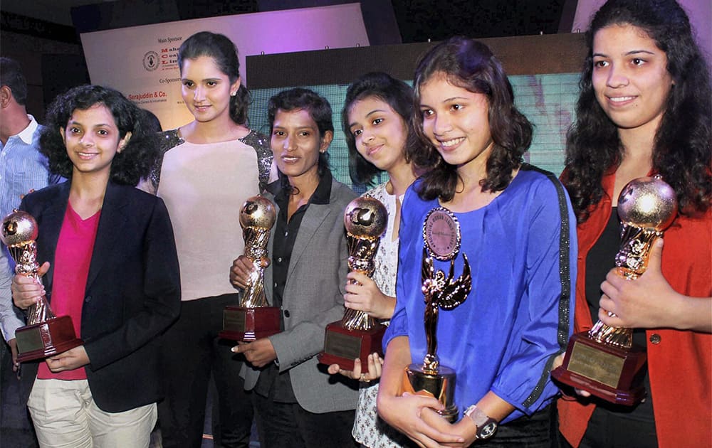 Ace tennis player Sania Mirza poses with sportswomen from Odisha during an event in Bhubaneswar.