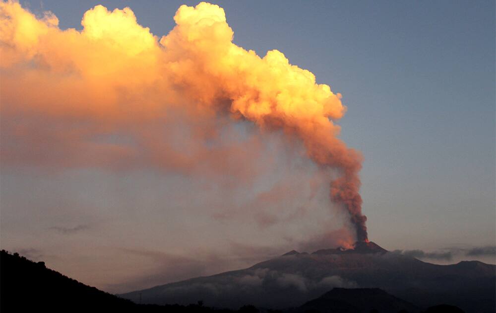 Smoke billows during an eruption of Mount Etna volcano as seen from the village of Viagrande, near the Sicilian town of Catania, Italy.